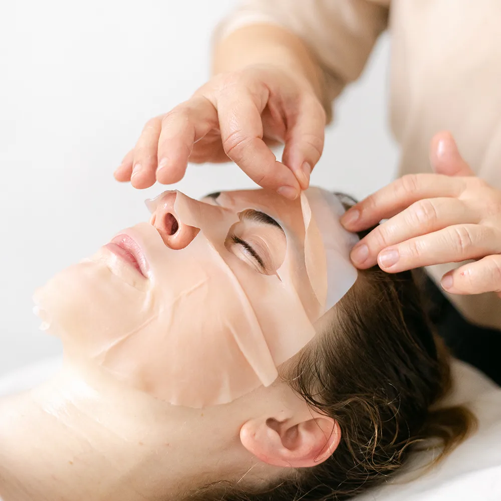 Beata Durtan performing a facial treatment